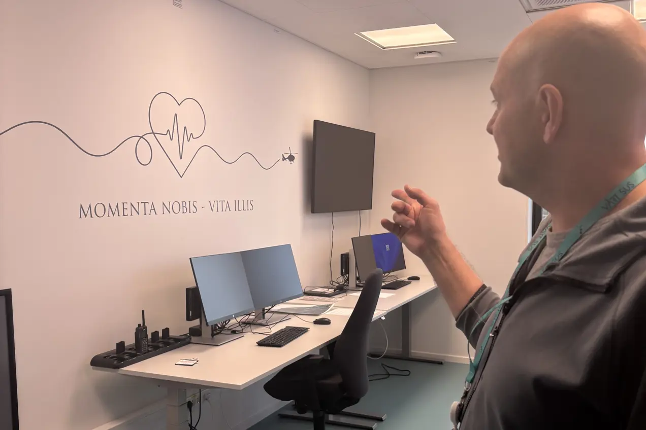 En mann som viser fram tekst på veggen